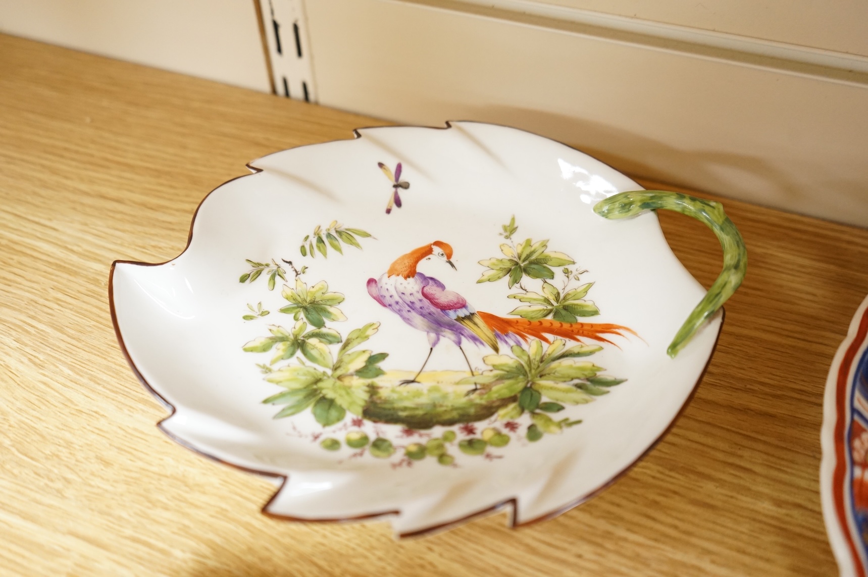 A collection of porcelain and pottery to include commemorative china, a leaf dish and group of wade figures, largest 29cm in diameter